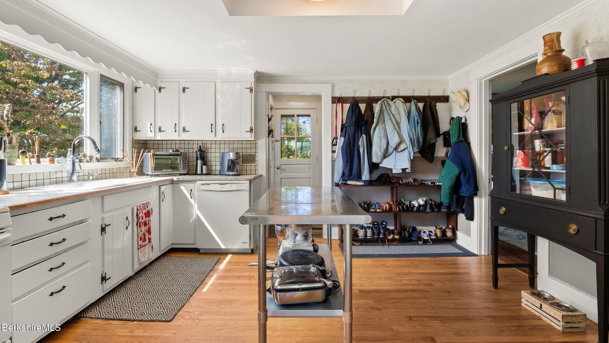 115 Baldwin Hill Road South Egremont, MA 01230 - Photo 28 of 36 a kitchen filled with white cabinets and wooden floor