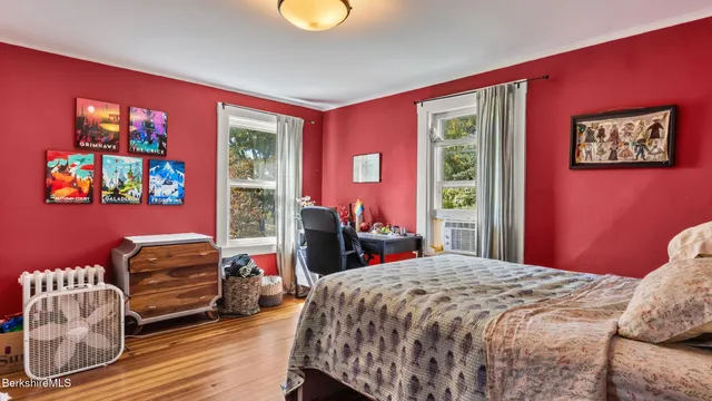 a bedroom with a bed and a potted plant