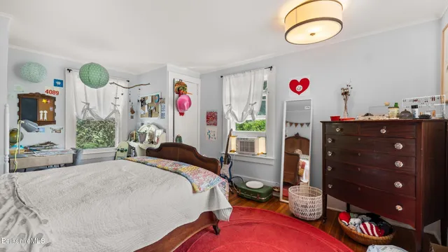 a bedroom with bed and a window