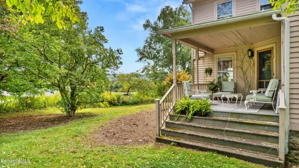 a view of backyard with deck and outdoor seating