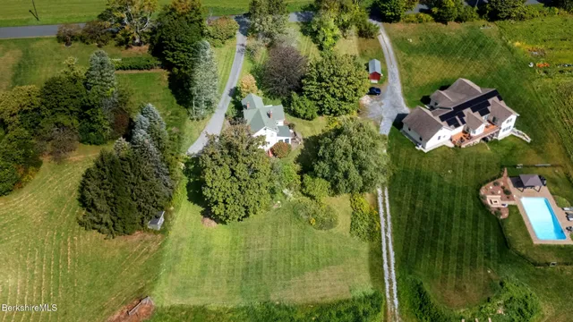 an aerial view of residential house with an outdoor space and seating