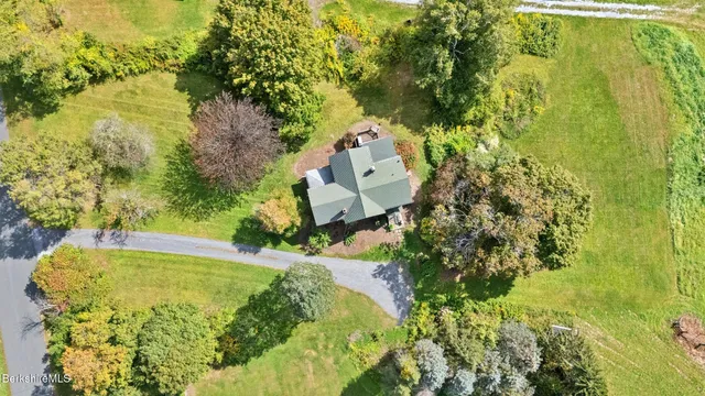 an aerial view of a houses with a lake view