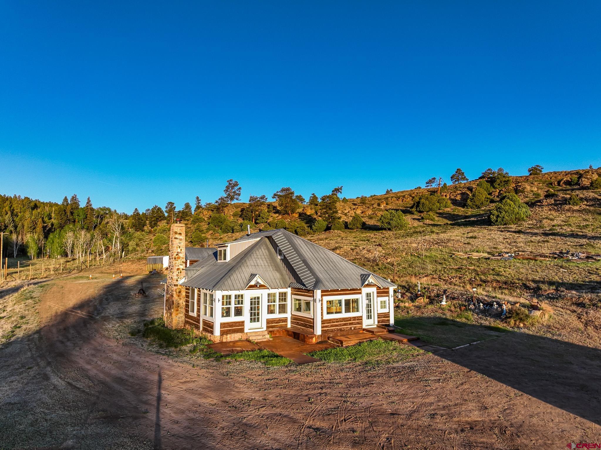 16431 Highway 149 Powderhorn, CO 81243 - Photo 15 of 24 a view of a big house with a big yard