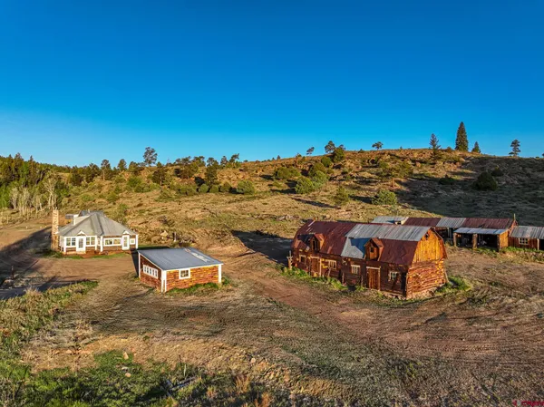 a view of a house with a yard and mountain view