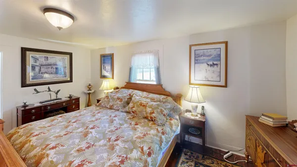a bedroom with a bed and a dresser