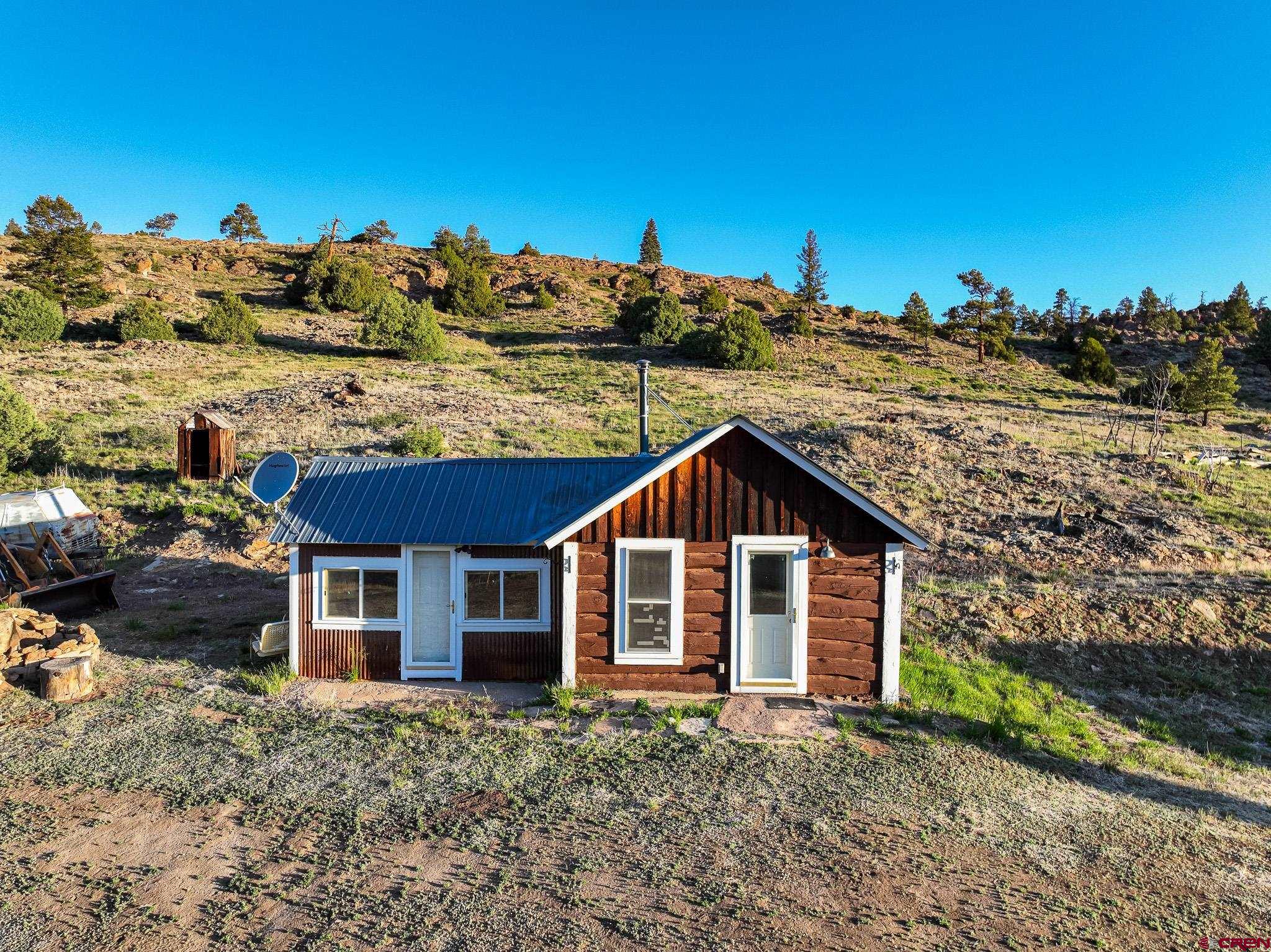 16431 Highway 149 Powderhorn, CO 81243 - Photo 24 of 24 a view of a house with a yard