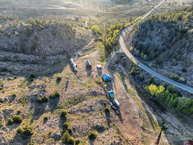 a view of a yard with wooden fence