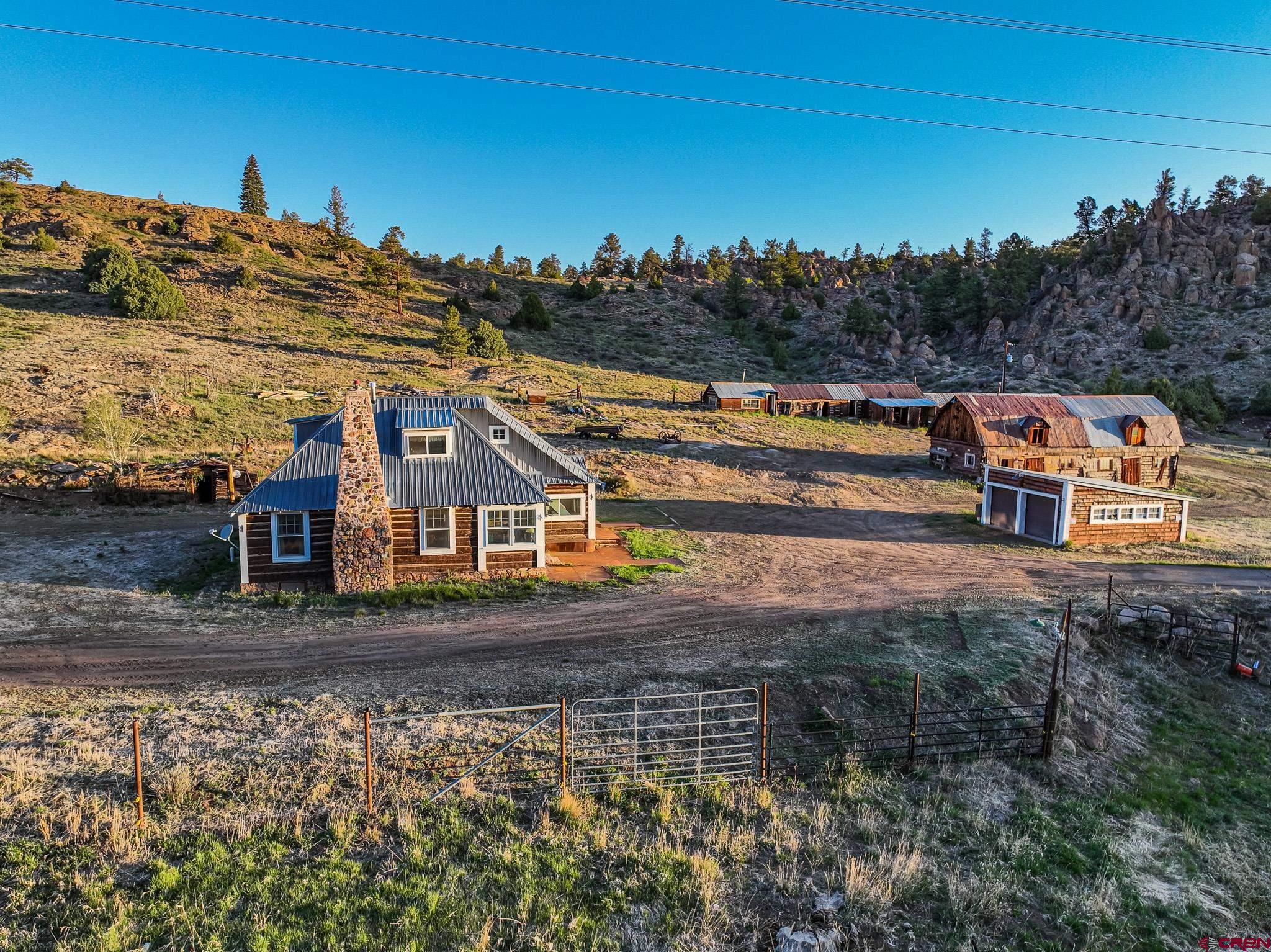 16431 Highway 149 Powderhorn, CO 81243 - Photo 8 of 24 front view of a house with a yard