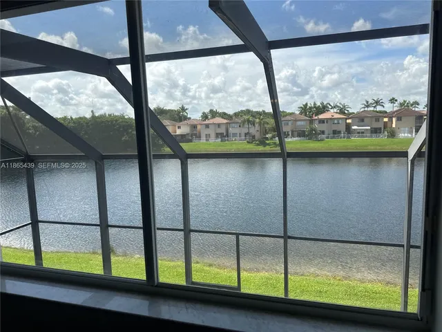 an empty room with wooden floor and a window