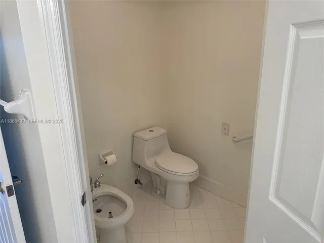 a bedroom with a bed and a potted plant