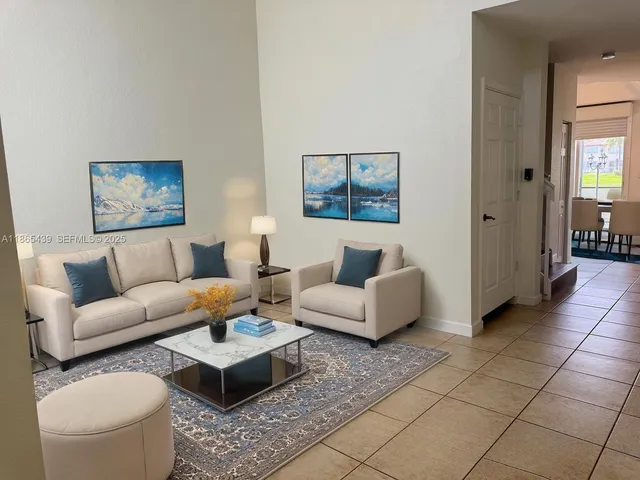 a living room with furniture and a rug