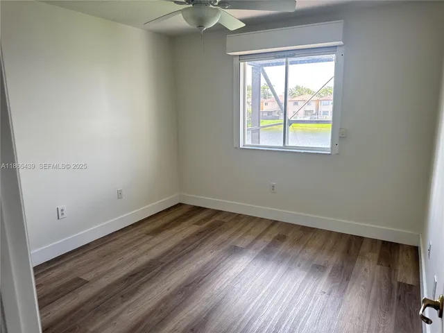 an empty room with wooden floor and closet
