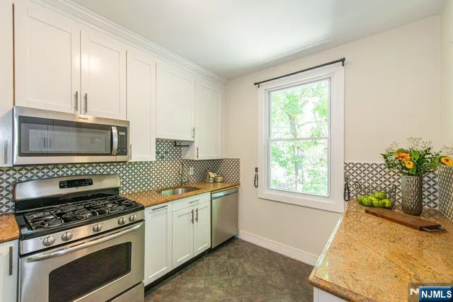 a kitchen with a refrigerator stove and sink