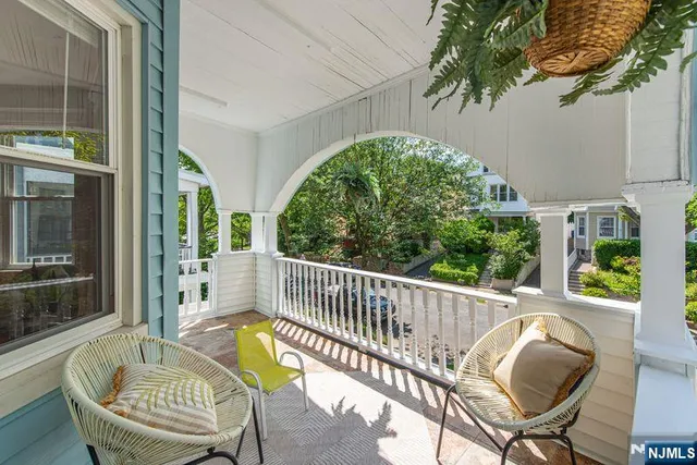 a view of a chair and tables in the balcony