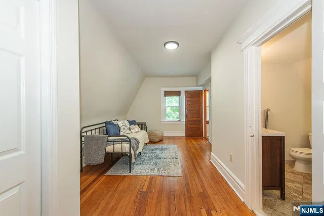 a bathroom with a toilet a sink and a mirror