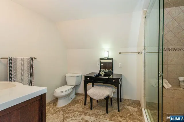 a bathroom with a double vanity sink mirror and shower