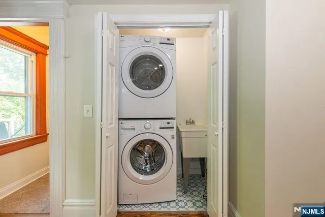 a view of a bedroom with a bed and wooden floor