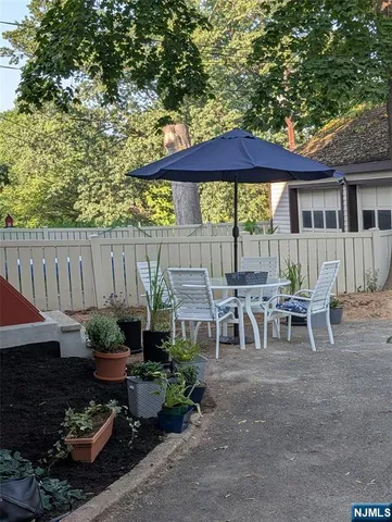 a patio table and chairs under an umbrella