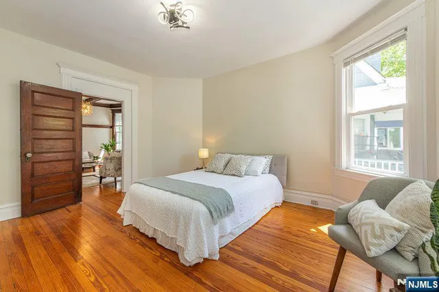 a living room with furniture a fireplace and next to a window