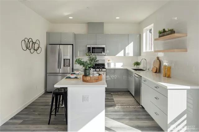 a kitchen with sink cabinets and refrigerator