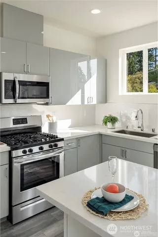 a kitchen with a stove and microwave