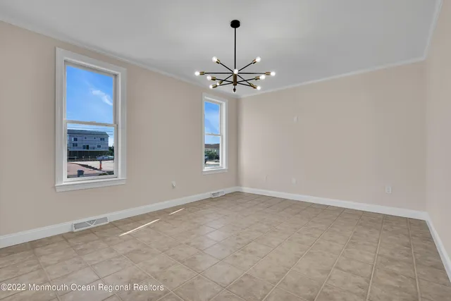 a view of an empty room with a ceiling fan and fireplace