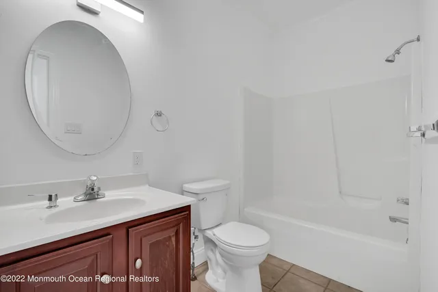 a view of a livingroom with a fireplace and window