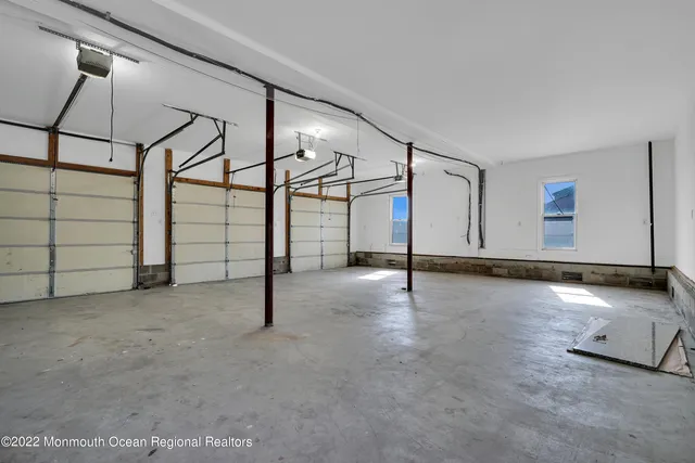 a view of a hallway with wooden floor and stairs