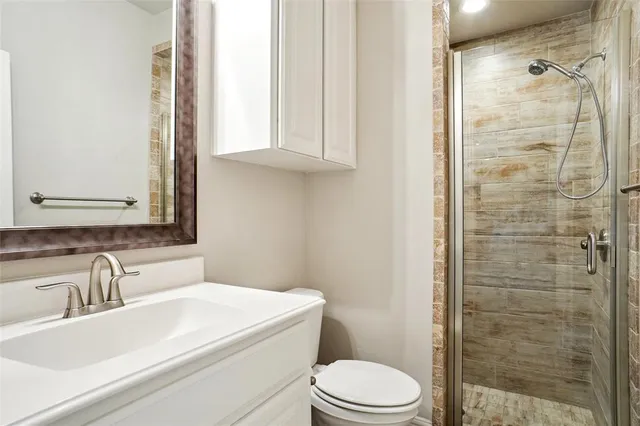 a kitchen with a refrigerator and a stove top oven