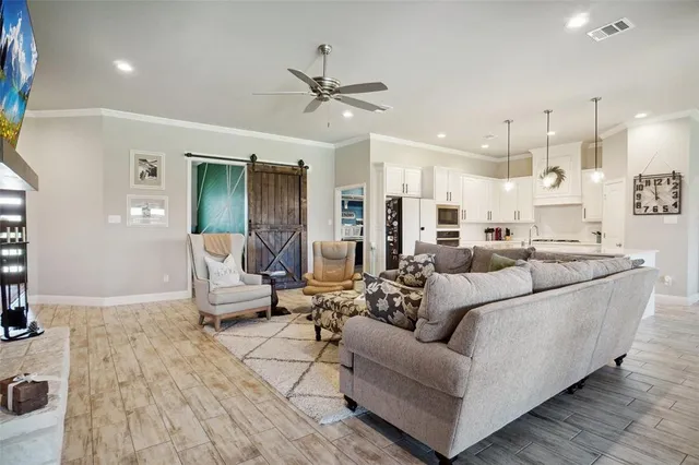 a living room with furniture and kitchen view