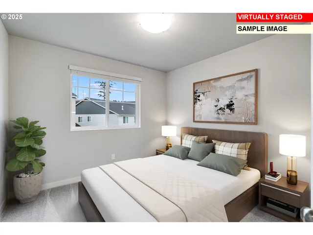 a bedroom with a bed and a painting on the wall