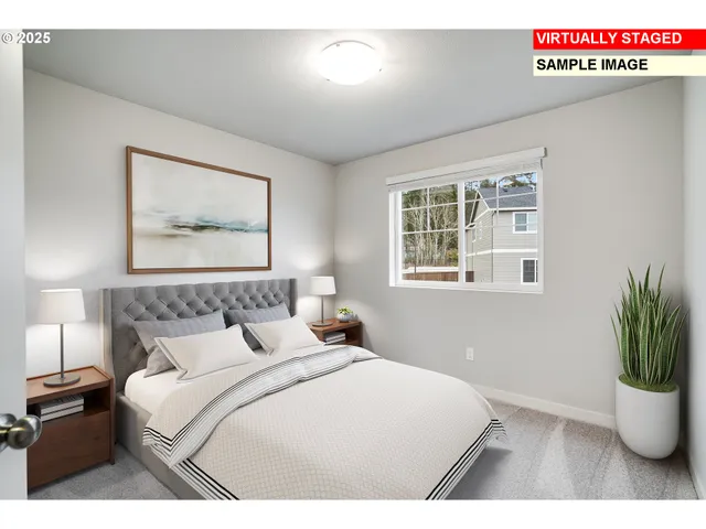 a bedroom with a large bed and a potted plant