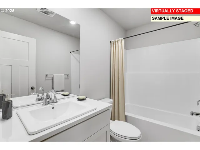 a bathroom with a sink a toilet a mirror and shower