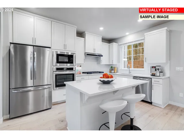 a kitchen with stainless steel appliances a refrigerator sink and cabinets