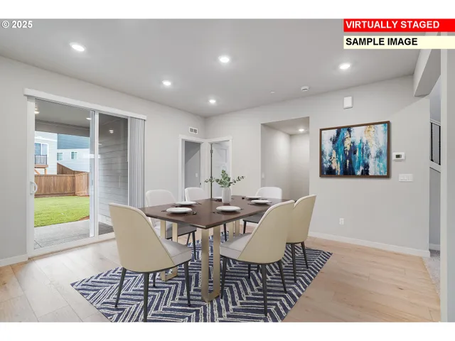 a view of a dining room with furniture wooden floor and a rug