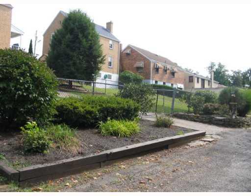 Other. Back alley entrance onto property through fence.