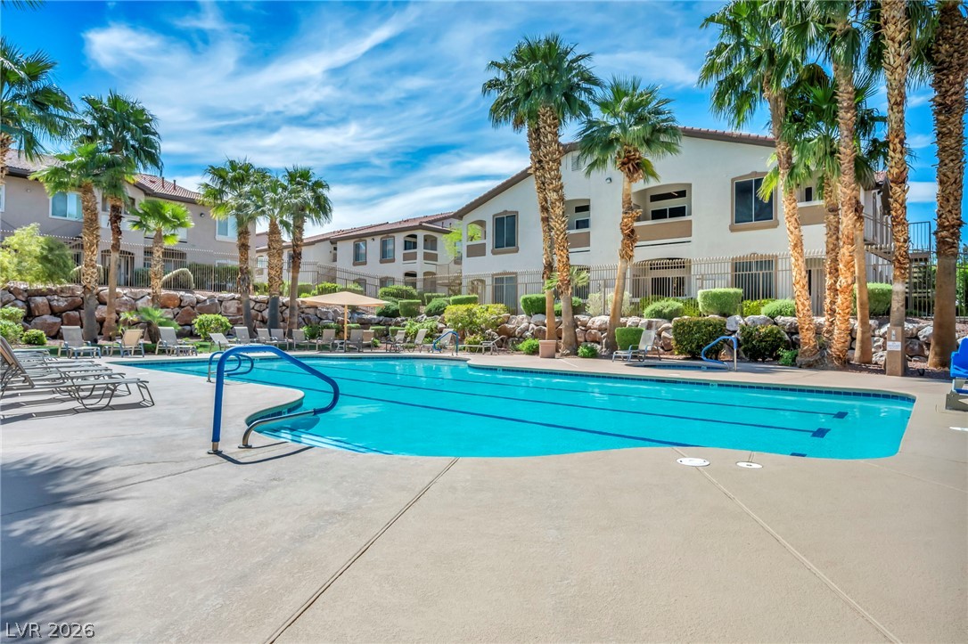 2305 West Horizon Ridge Parkway, Unit 3621 Henderson, NV 89052 - Photo 22 of 23 An inviting swimming pool surrounded by tropical palm trees offers a refreshing escape.