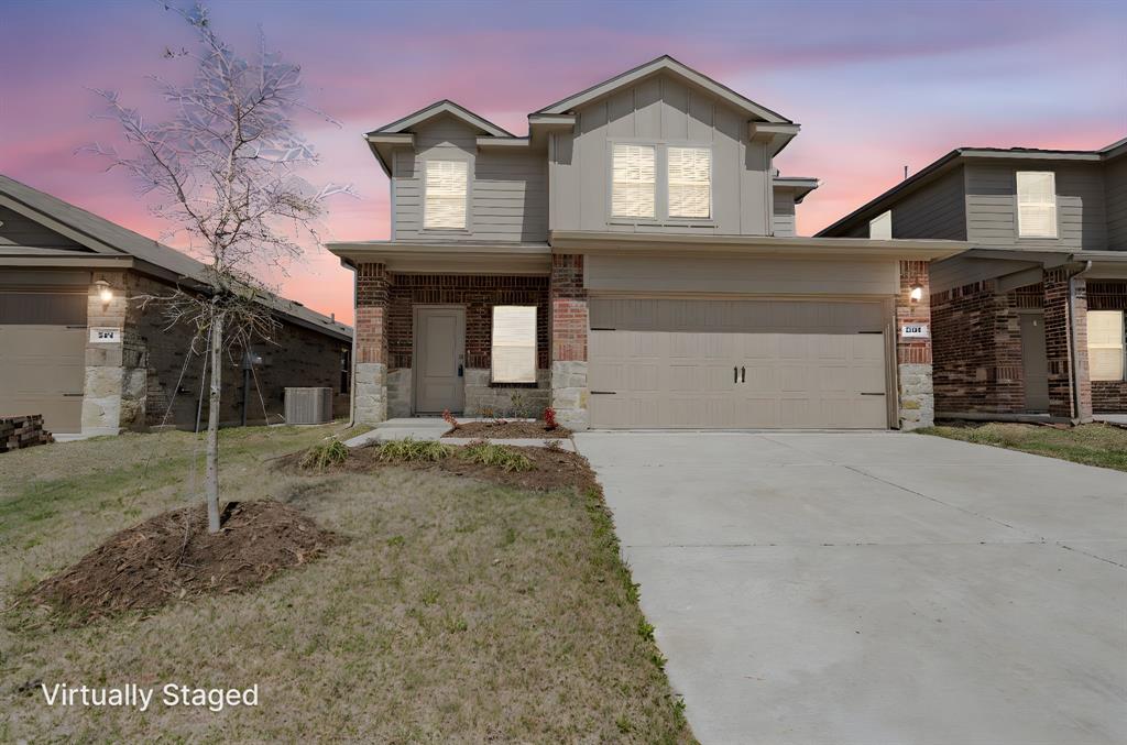 a front view of a house with a yard and garage