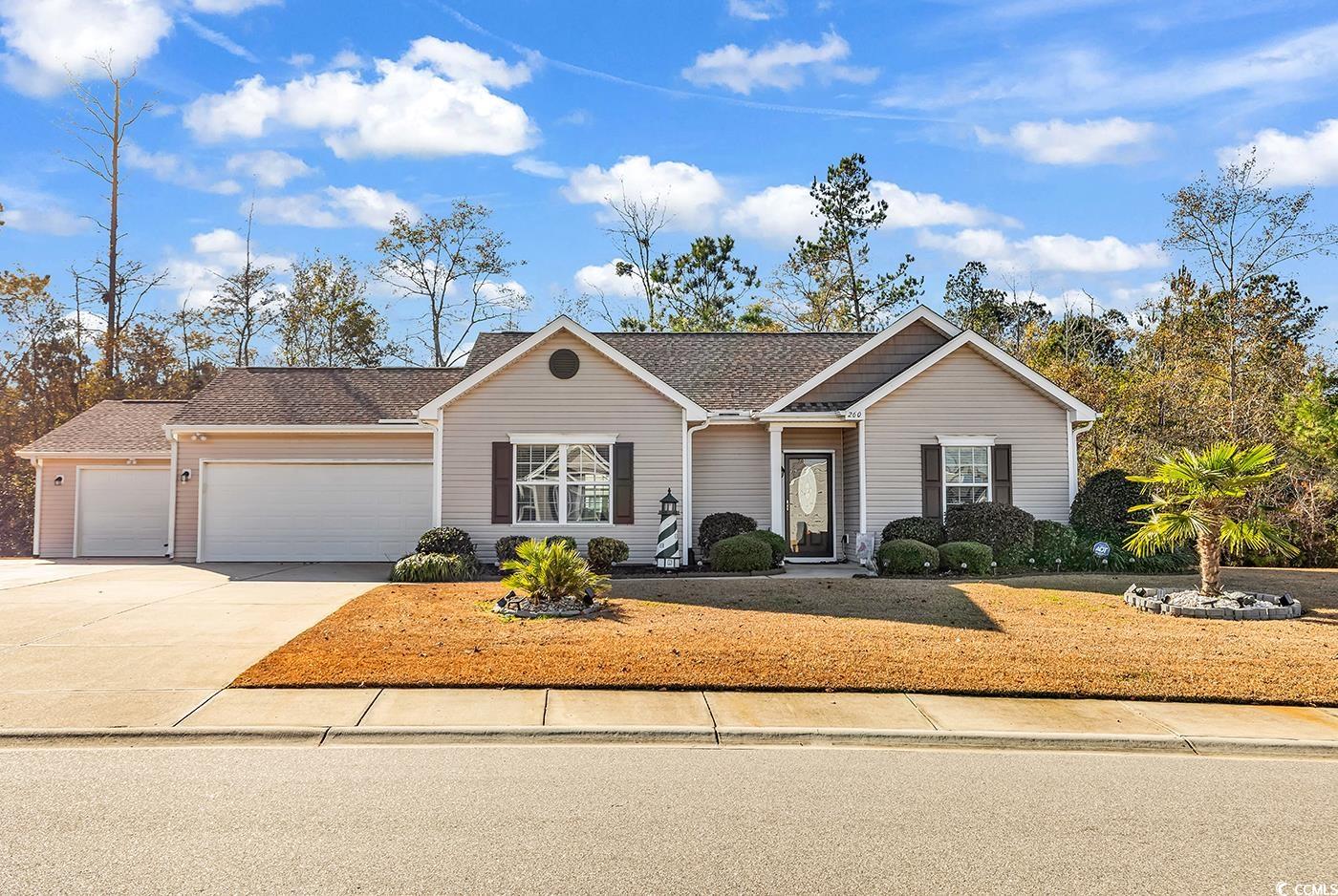 Single story home featuring driveway, an attached garage, and a shingled roof