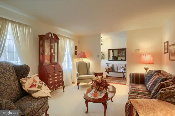 a living room with furniture fireplace and a window