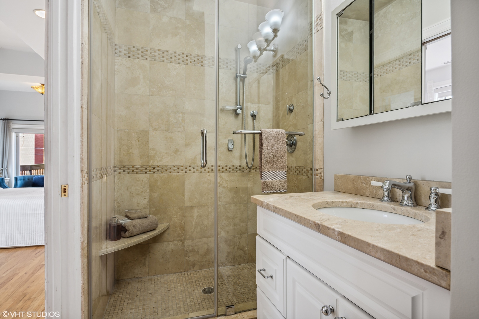 626 West Belden Avenue, Unit 2 Chicago, IL 60614 - Photo 16 of 17 a bathroom with a granite countertop sink a mirror and shower