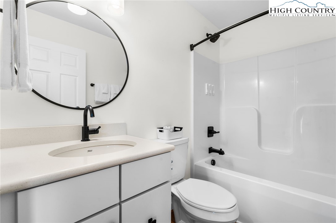 429 Townhomes Place, Unit 18 Boone, NC 28607 - Photo 19 of 25 a bathroom with a sink a toilet and a mirror