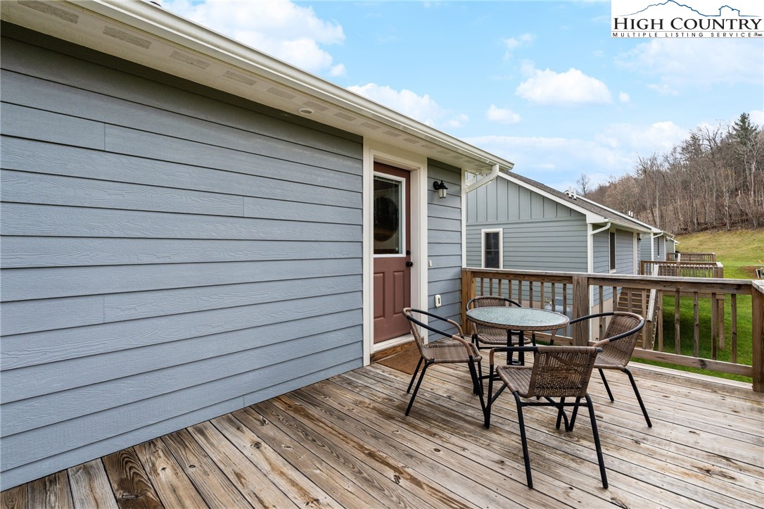 429 Townhomes Place, Unit 18 Boone, NC 28607 - Photo 21 of 25 a roof deck with a dining table and chairs with wooden floor