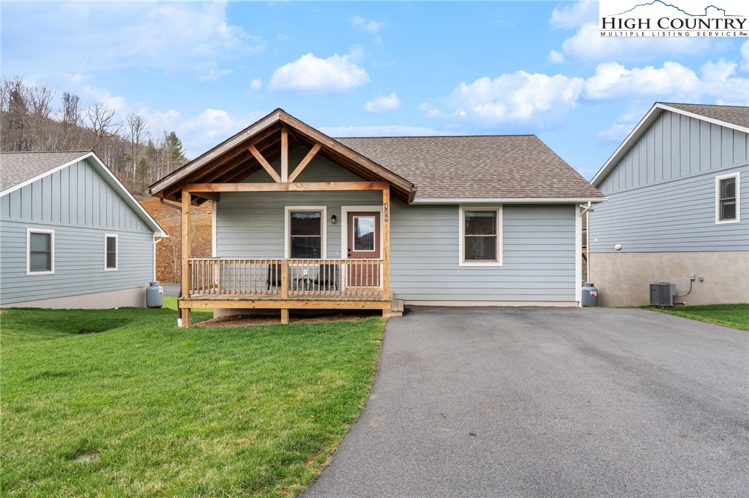 429 Townhomes Place, Unit 18 Boone, NC 28607 - Photo 3 of 25 a front view of a house with a yard and garage