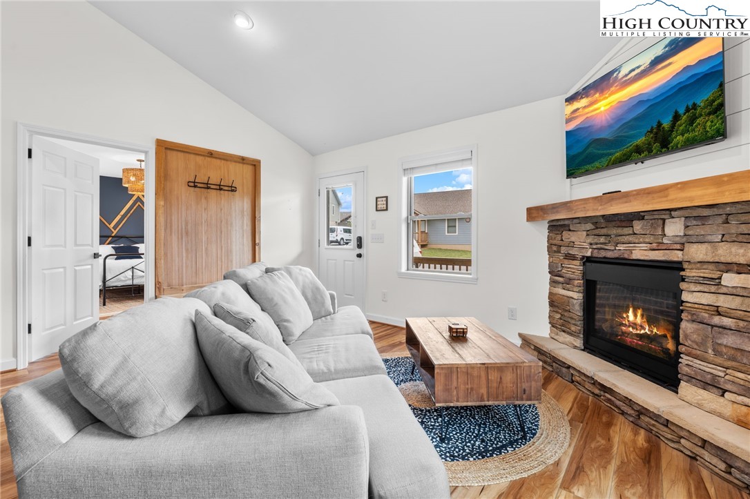 429 Townhomes Place, Unit 18 Boone, NC 28607 - Photo 4 of 25 a living room with furniture a flat screen tv and a fireplace
