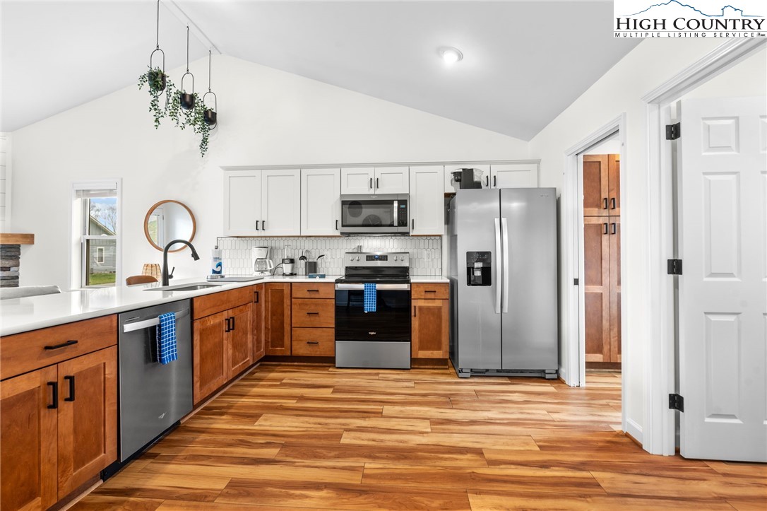 429 Townhomes Place, Unit 18 Boone, NC 28607 - Photo 8 of 25 a kitchen with stainless steel appliances granite countertop a refrigerator and a stove top oven