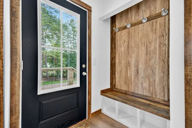 a view of a dresser with wooden floor and walls