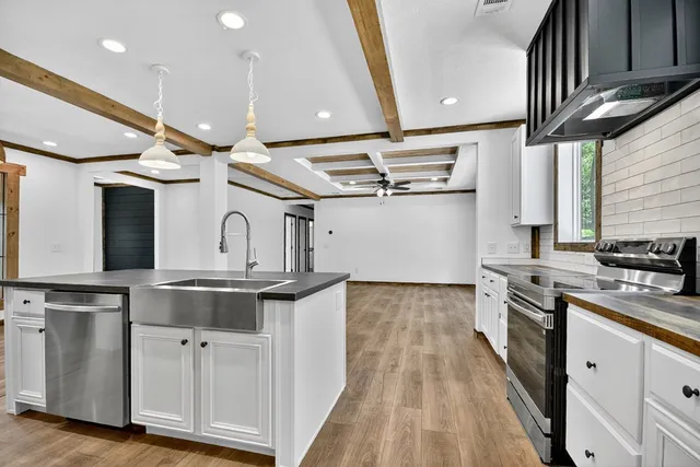 a kitchen with stainless steel appliances granite countertop a stove and a refrigerator