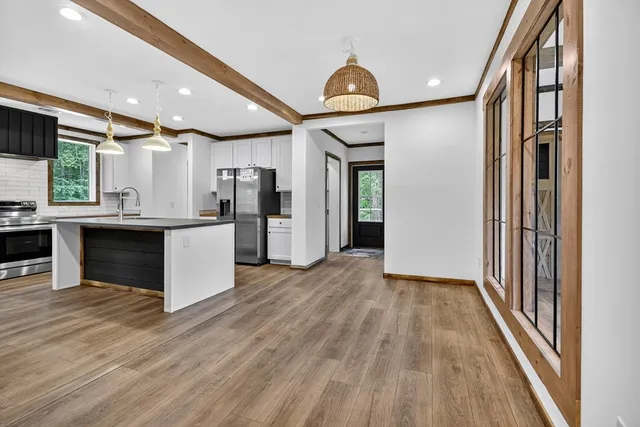 a view of kitchen with cabinets and wooden floor