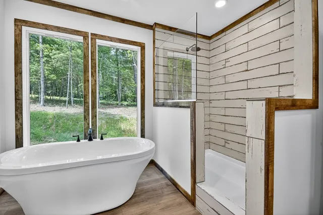 a bathroom with a bathtub and shower